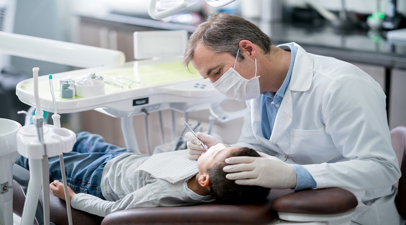 Things Every Parent Should Know About Baby Teeth Pediatric dentist checking teeth on a boy