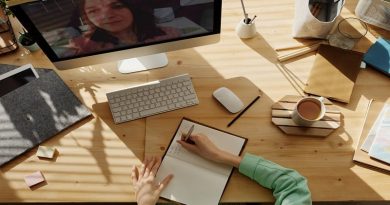 Learning From The Comfort of Your Home Person writing in notebook at desk while on the computer