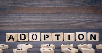 Adopting a Child Adoption spelled out in small wood tiles
