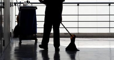 Commercial Cleaning Brisbane Cleaner mopping floor with cleaning cart in background