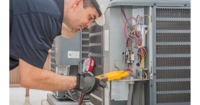 How to Find an HVAC Contractor HVAC repairman reading volt meter on HVAC Unit
