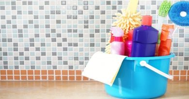 Best Disinfecting Practices Small blue bucket filled with cleaning supplies sitting on kitchen counter