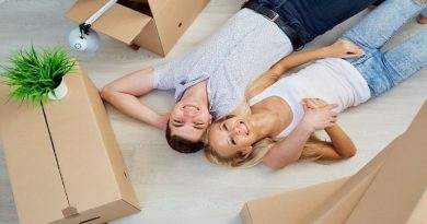 Guide To Moving Out Young couple surrounded by moving boxes