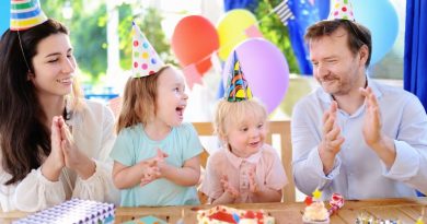 Adults and children wearing party hats at a birthday party