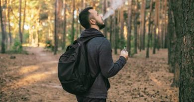 Buying Vape Juice Online Bearded man with backpack vaping in the woods