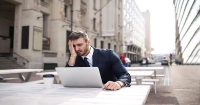 Hidden Health Hazards In Your Workplace Frustrated man at outdoor table looking at his laptop