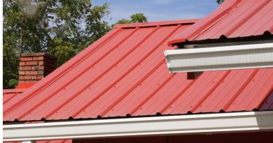 Metal Roofing Systems Home with Red Metal Roof