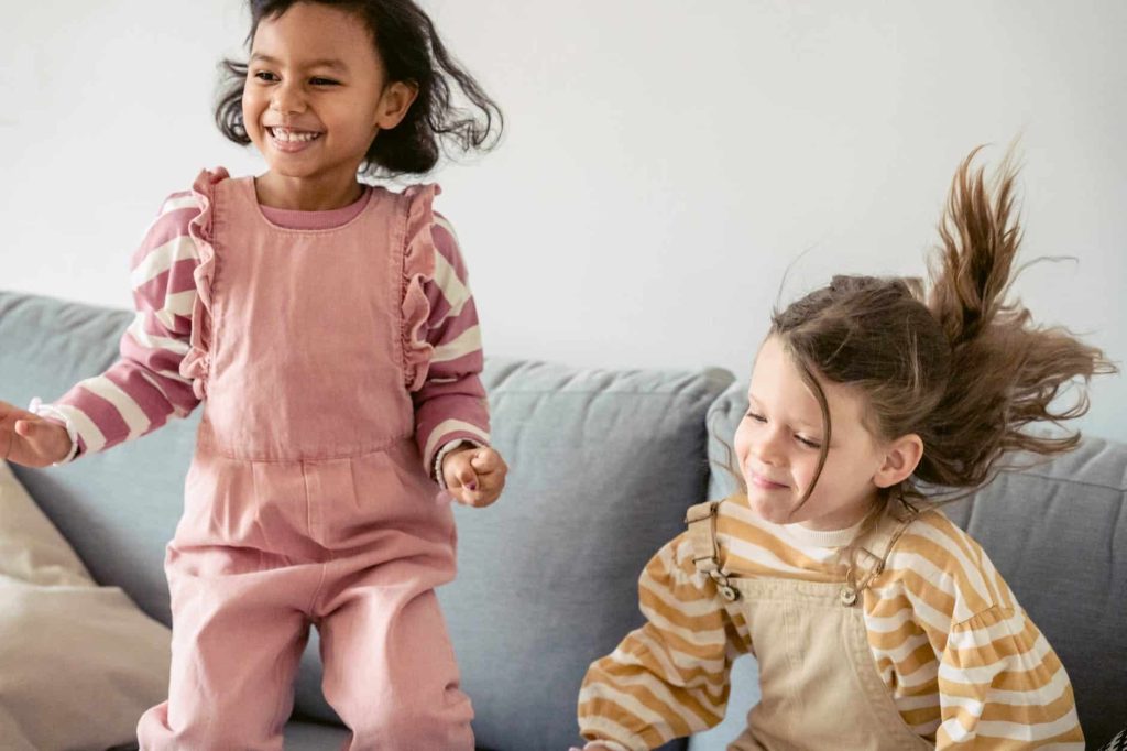 Little girls jumping on a sofa Finding The Perfect Place To Live For You And Your Family