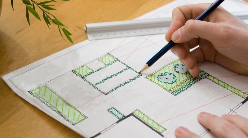 Person drawing a landscape design