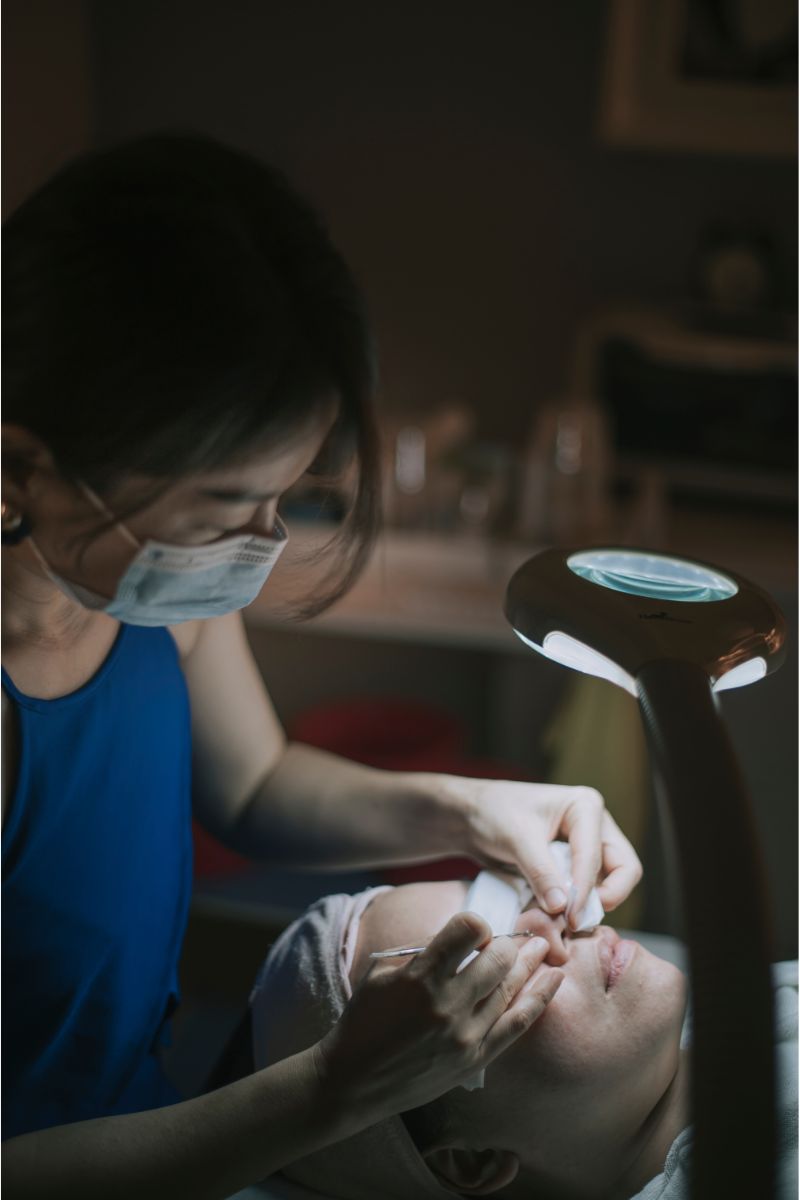Woman receiving facial extractions.