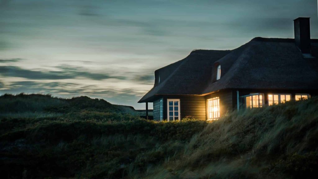 Common Roof Problems Home on side of hill at dusk