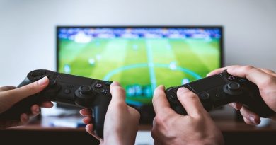 At-Home Activities For You and Your Partner Man and woman playing video games together on big screen TV