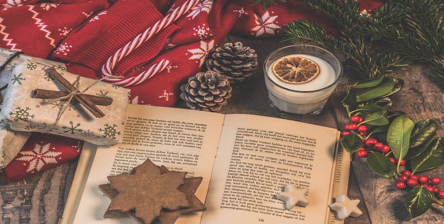 Open Book on Table with Christmas Decorations