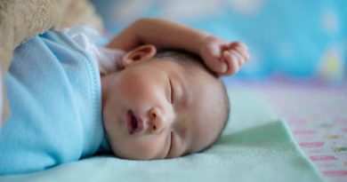 Tips to Keep You and Baby Comfortable / Newborn baby boy laying on his side