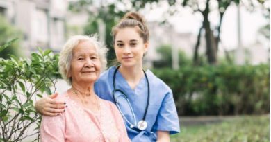 Nurse with her arm around an elderly woman