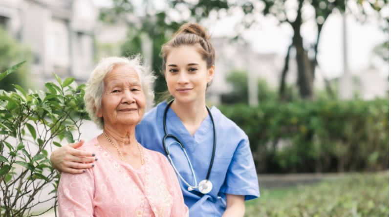 Nurse with her arm around an elderly woman