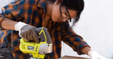Woman cutting wood with jigsaw
