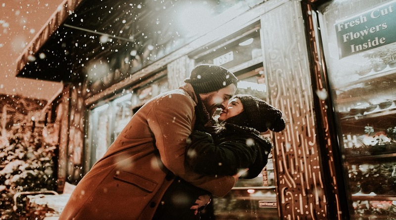Greeting the New Year with a Stronger Relationship / Couple snuggling outside in the snow.