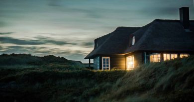 Creating a Comfortable and Safe Home / Home on side of hill at dusk