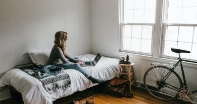 Perfect Location To Start Your WFH Lifestyle / Woman sitting on her bed working on a laptop