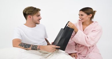 Choosing the Perfect Gift / Man giving a gift bag to a woman both are smiling