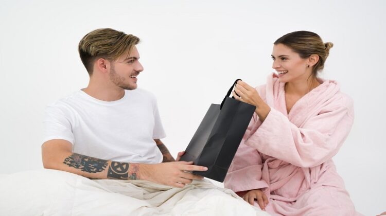 Choosing the Perfect Gift / Man giving a gift bag to a woman both are smiling