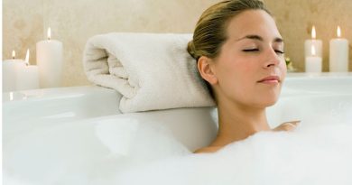 De-Stressing / Woman in a bubble bath surrounded by candles and flowers