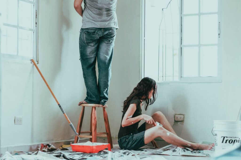 Couple painting walls in their home
