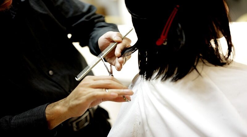 Stylist cutting a woman's hair