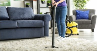 Keeping Your Home Looking Brand New / Woman vacuuming the shag rug in her tidy living room