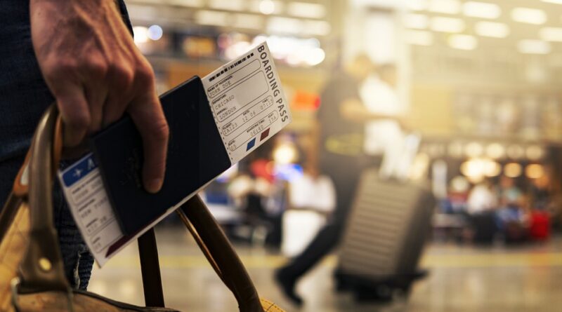 travel-person at airport with bag, passport, and boarding pass