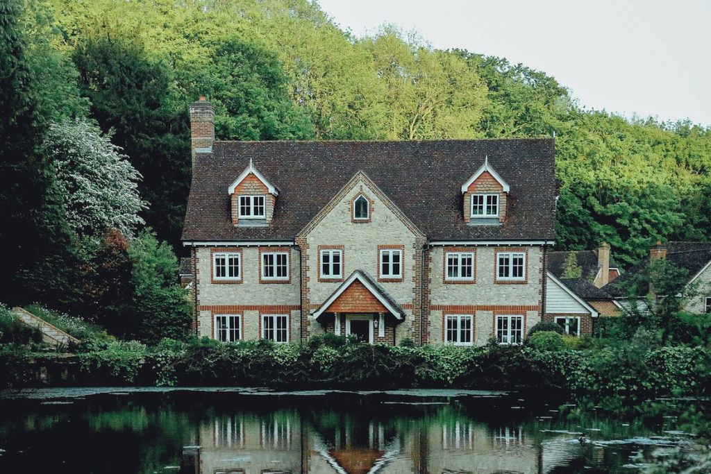 Old style 3 story brick home on the water in small English town