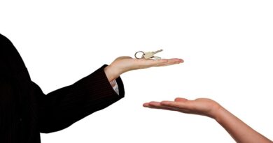 Increase Your Home Sale Potential / Person in black suit holding home keys and another persons outstretched hand