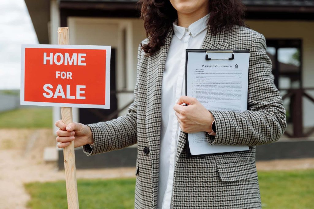 Get The Best Price When You Sell Your Home / Real Estate Agent with Clipboard in one hand and a For Sale Sign in the other Hand
