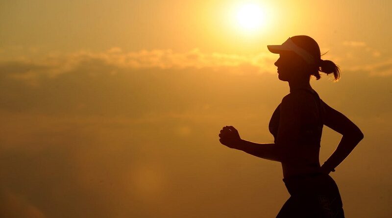 Motivate Yourself to Exercise / Woman running as the sun comes up