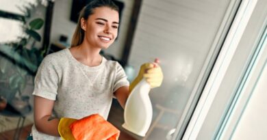 Home Cleaning Tips / Woman in rubber gloves cleaning her sliding glass door