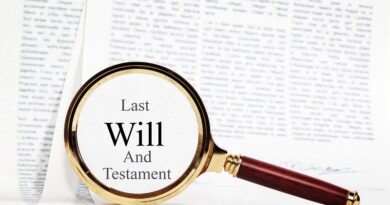 Beneficiaries of Wills and Estates / Magnifying Glass on top of legal papers highlighting the words last will and testament