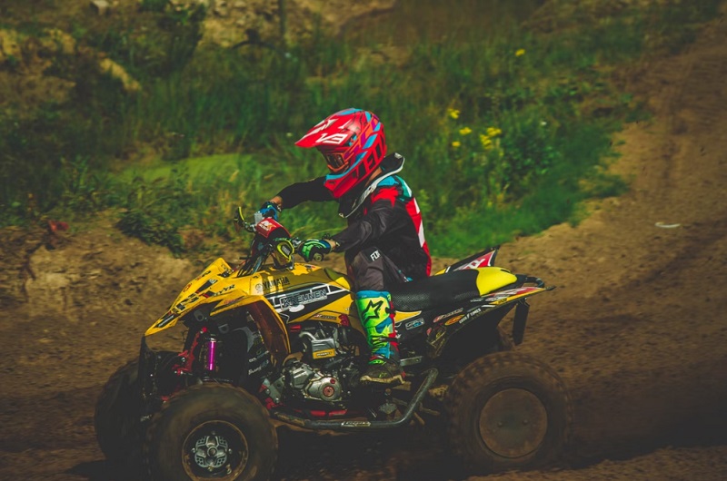 Outdoor Hobbies: 5 Cool Activities To Try / Person in red helmet riding a bright yellow dirt bike