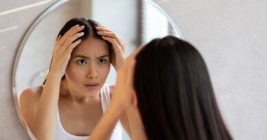 Hair Growth Serums vs. Hair Growth Supplements / Worried Woman Looking in the Mirror at Her Hair