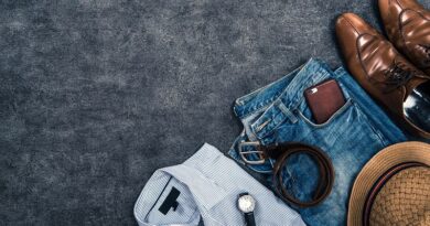 5 Accessories Every Guy Needs In Their Wardrobe / Flat lay of Mens Shirr Jeans Belt Watch Wallet Hat and Shoes
