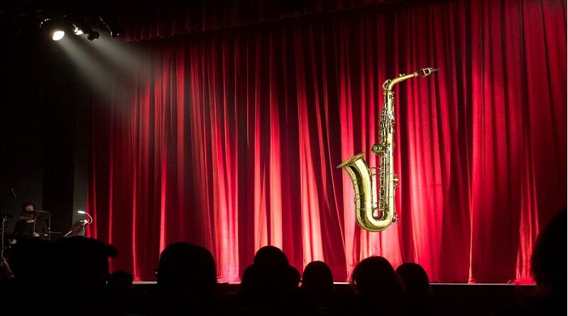 Saxophone in the Theatre- 3 Great Plays to See / Theater Stage with Red Drapes Saxophone and Silhouettes of the Audience