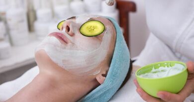 How To Achieve Happy, Healthy, Glowy Skin / Woman with cucumber slices on her eyes being given a facemask treatment