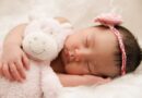 10 Ways to Keep Your Newborn Healthy / Sleeping baby girl, holding a stuffed animal