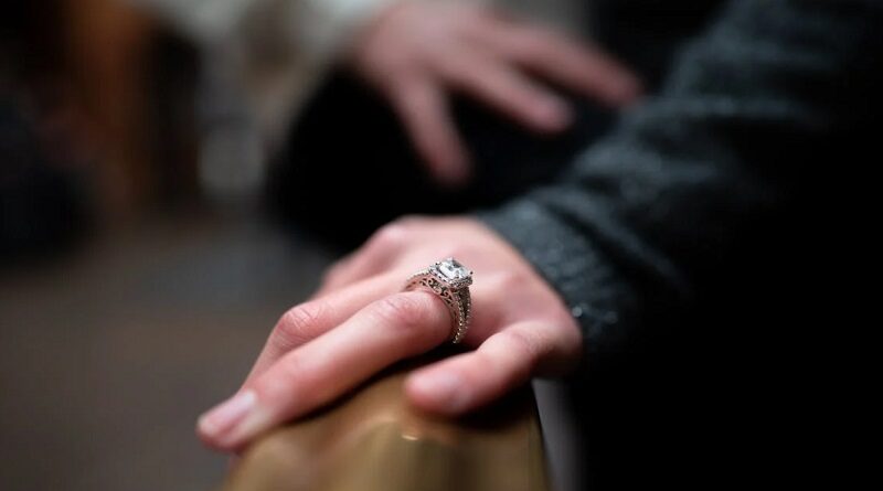 Woman's hand with a diamond engagement ring