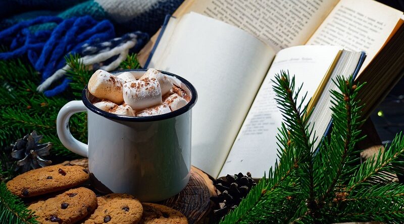 Books, cookies, mug of cocoa, and holiday greenery