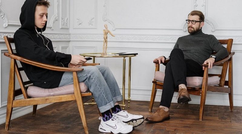 Community Mental Health / Sad young man with his therapist