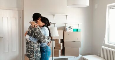 First-Time Homebuyer in Washington State / Couple hugging in their new home, surround by packed boxes