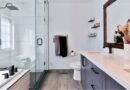 Bright airy bathroom with glass enclosed bath and shower