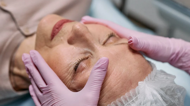 What Are Crow’s Feet / A person wearing pink latex gloves touching the face of an older woman who has her eyes closed
