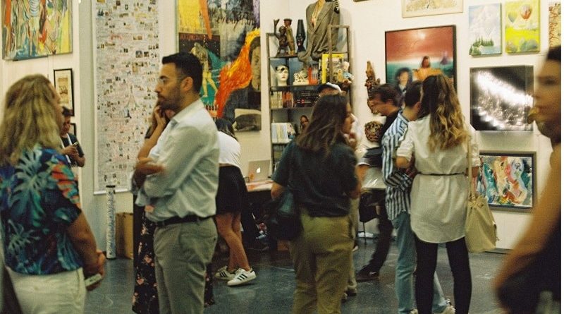 Choosing Unique Art Pieces for Interior Design / A roomful of people looking at art in a gallery